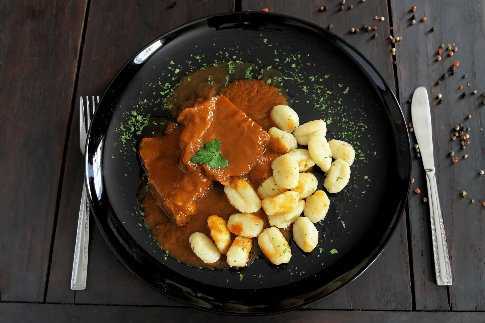 Pasticada with gnochhi served on a plate