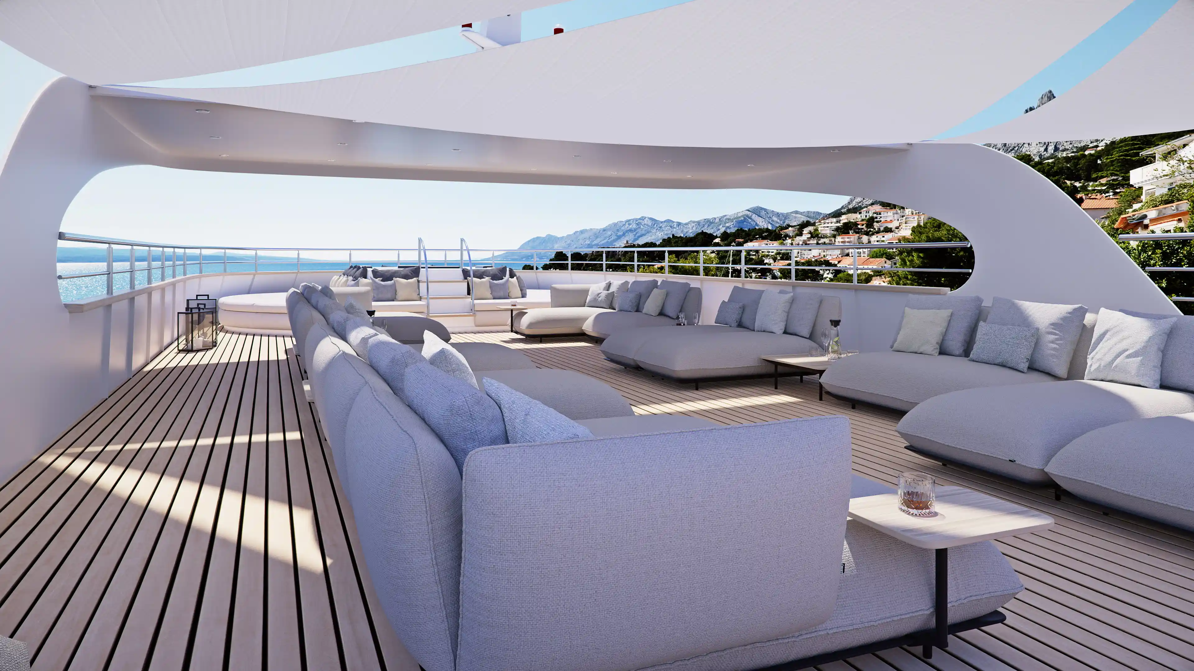 Luxurious terrace with tables and beverages surrounded by the sea, mountains and city